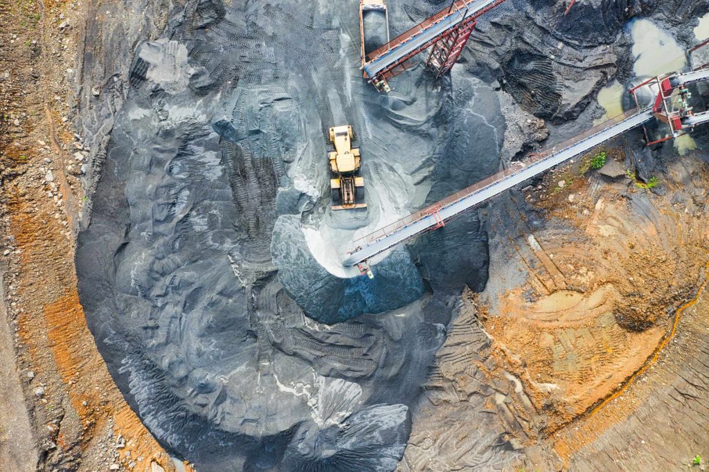 An overhead view of a digger in a coal mining site